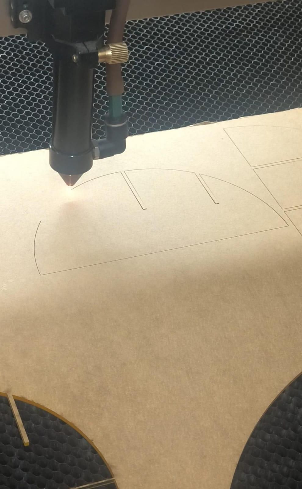 laser cutting the acrylic.jpeg
