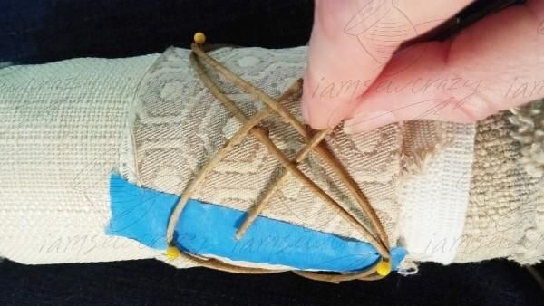 weaving vines around fabric roll.jpg