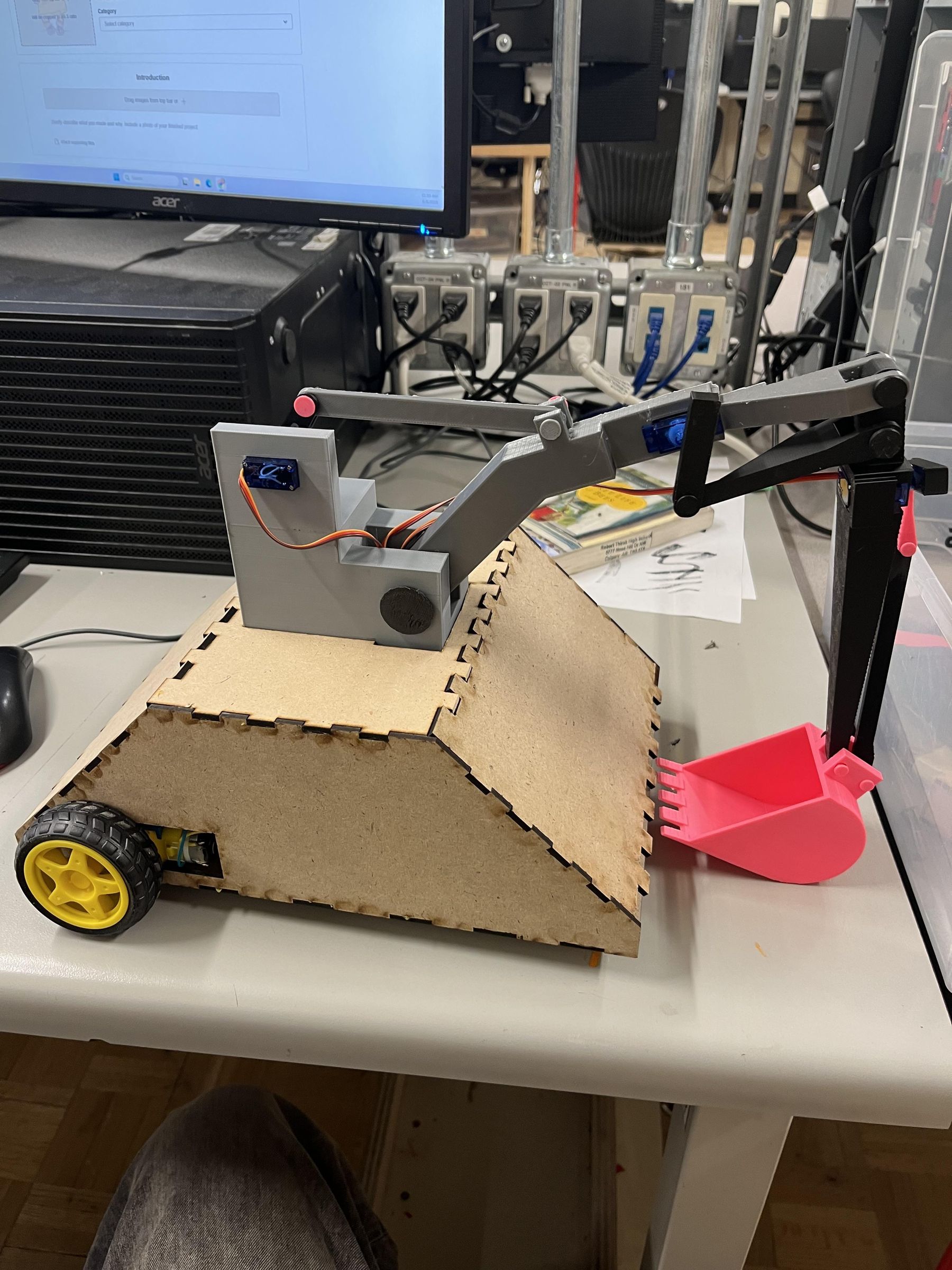 I Made an Excavator With a Working Arm to Scoop Things As Well As Working Motors That Make It Drive and Turn.